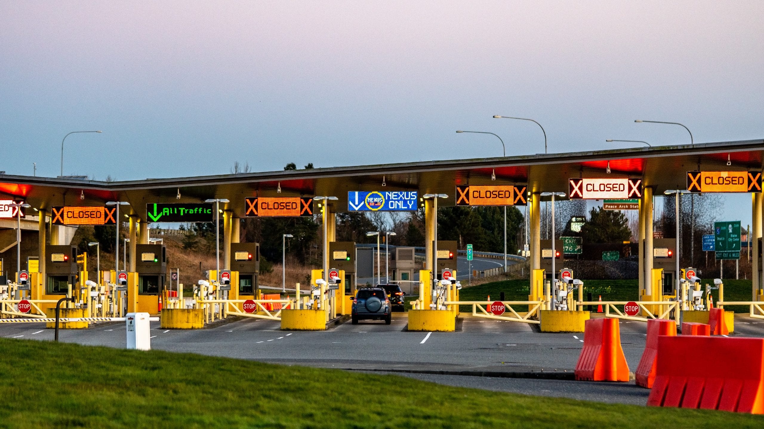 US/Canada Border, Peace Arch, Washington State, USA. Empty border lanes at crossing between US and Canada.