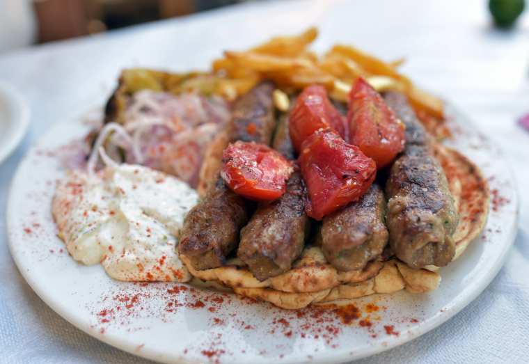 Greek Souvlaki. Lamb Skewer on a Plate with Potatoes and Tzatziki, Geece